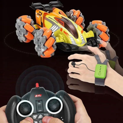 Green stunt RC car shown from front-side with controller handle in hand 