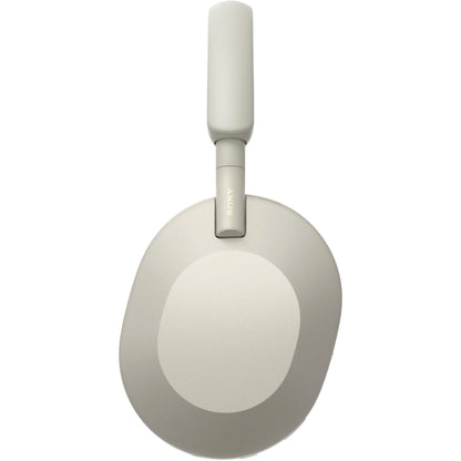 Side-angle of silver WH-1000XM5 showing earcup texture and padded headband