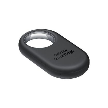 Close-up of the Samsung Galaxy SmartTag2 Black attached to a silver keyring with house keys.