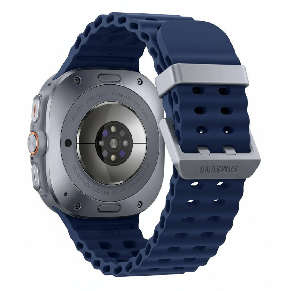 Galaxy Watch Ultra 47mm Titanium Silver with dark marine band resting on a rocky surface beside a climbing rope.