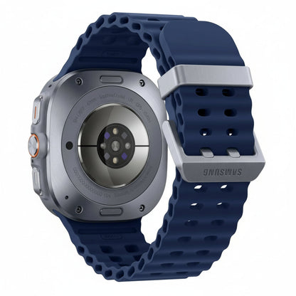 Galaxy Watch Ultra 47mm Titanium Silver with dark marine band resting on a rocky surface beside a climbing rope.